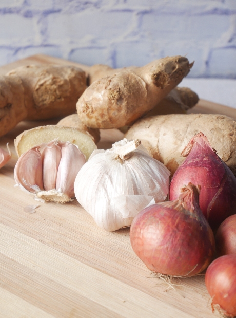 Ginger, garlic, and onions on table - Home Style Products ingredients